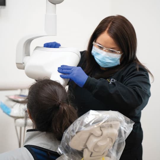 A Soleil team member positioning a patient in the i-CAT 3D cone beam scanner