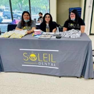 The Soleil team at a community event table