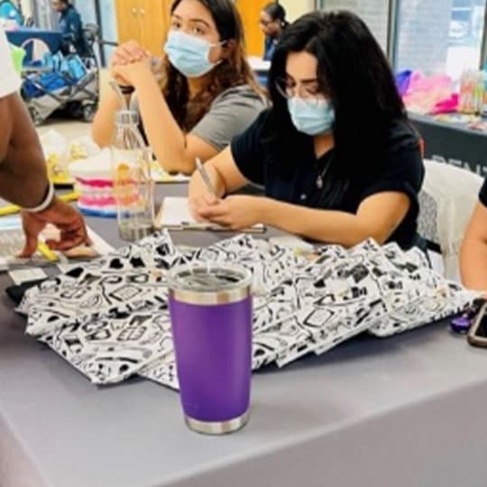 Team members at a community crafts table