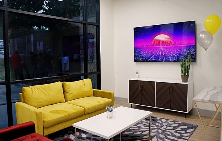 The Soleil lobby with a yellow sofa and big storefront windows