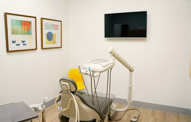 A treatment room at Soleil Dental with a TV on the wall