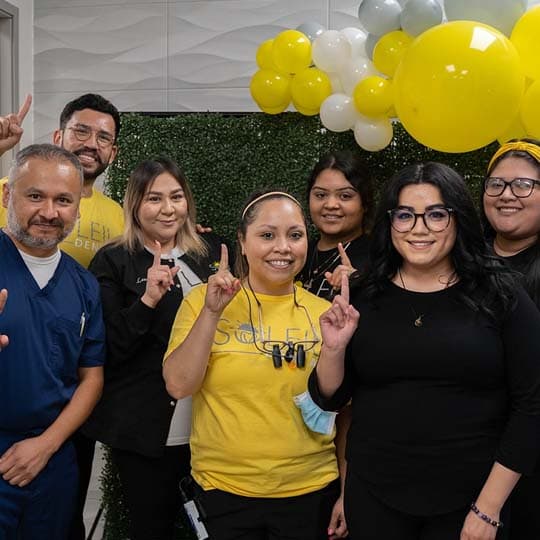 The team celebrating the grand opening with yellow balloons