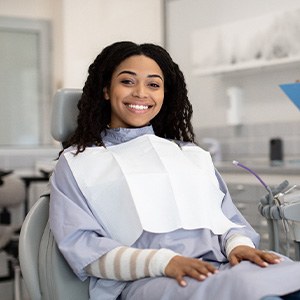 Woman smiling while sitting in treatment chair