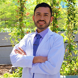 Dentist smiling with arms folded