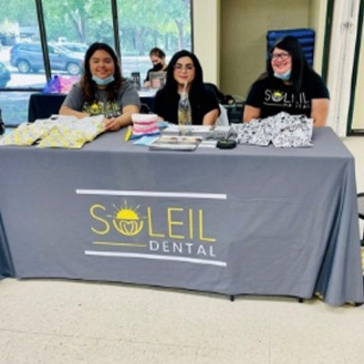 Dental team at Soleil Dental table