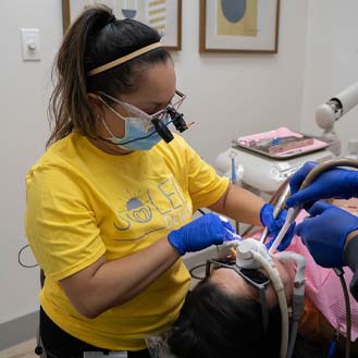 Dental team member treating a patient