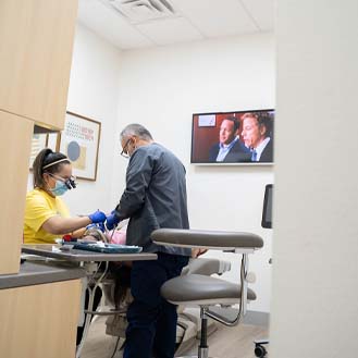 Far shot of dental team treating a patient