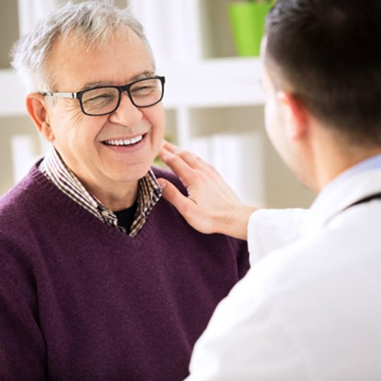 a patient visiting their dentist to receive dentures