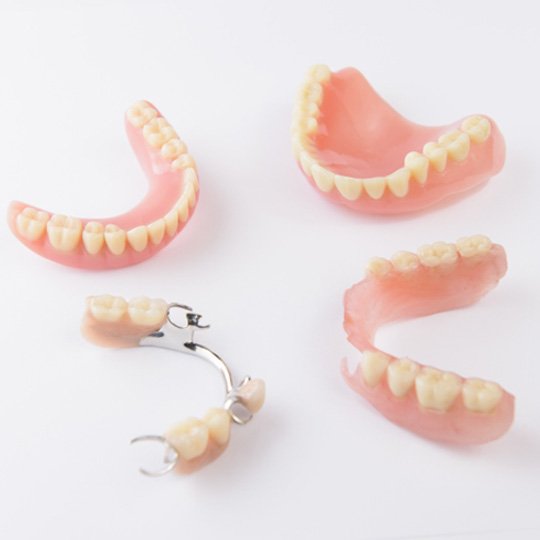 various types of dentures against a white background
