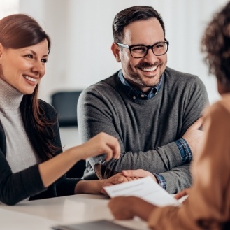 Dentist and patients discussing the cost of treating dental emergencies