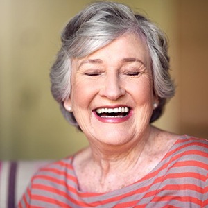 Woman smiling while sitting in her favorite chair