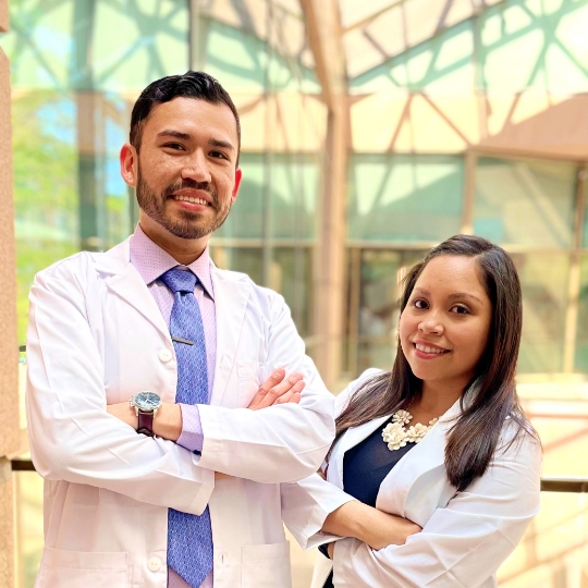 Dallas Texas dentists Doctor Vazquez and Doctor Aldana standing and smiling with arms crossed