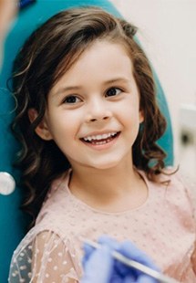 a child getting dental treatment from her dentist near Uptown