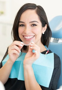 a patient getting Invisalign from her dentist near Uptown
