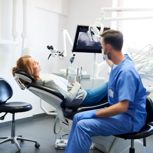 Dentist talking to dental patient