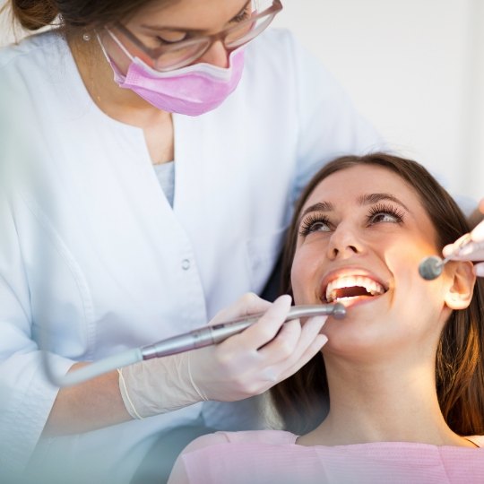 Dentist examining dental patient's smile