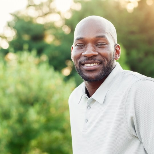 Man with healthy smile after dental implant tooth replacement