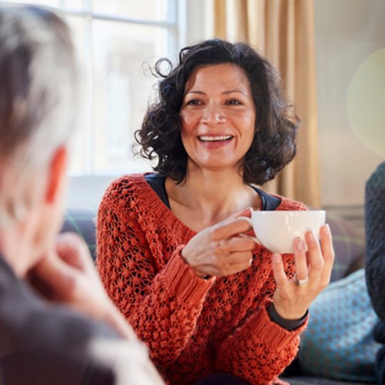 middle-aged woman having tea with friends  