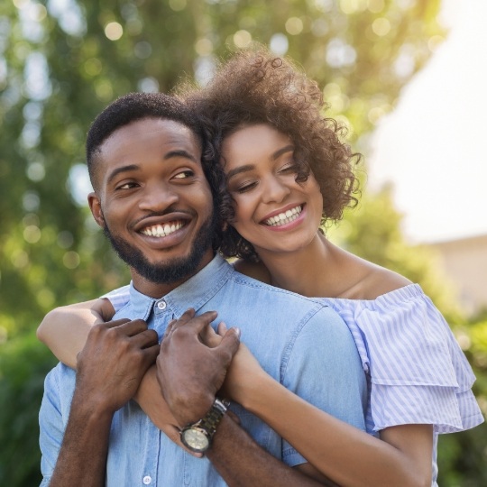 Young couple with straight teeth after Invisalign treatment