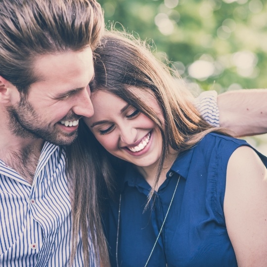 Man and woman with healthy smiles after restorative dentistry