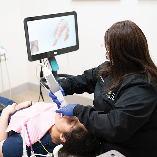 Dentist using intraoral camera to capture smile photos