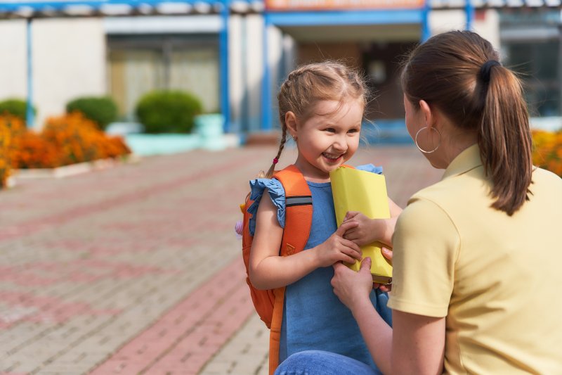 parent helping child to prevent dental emergencies in Dallas