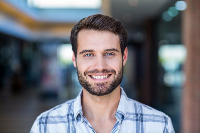 person with porcelain veneers smiling