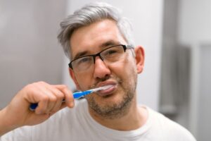 Middle-aged man brushing his teeth