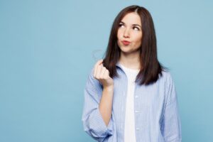 Woman wondering if her retainer can re-straighten her teeth